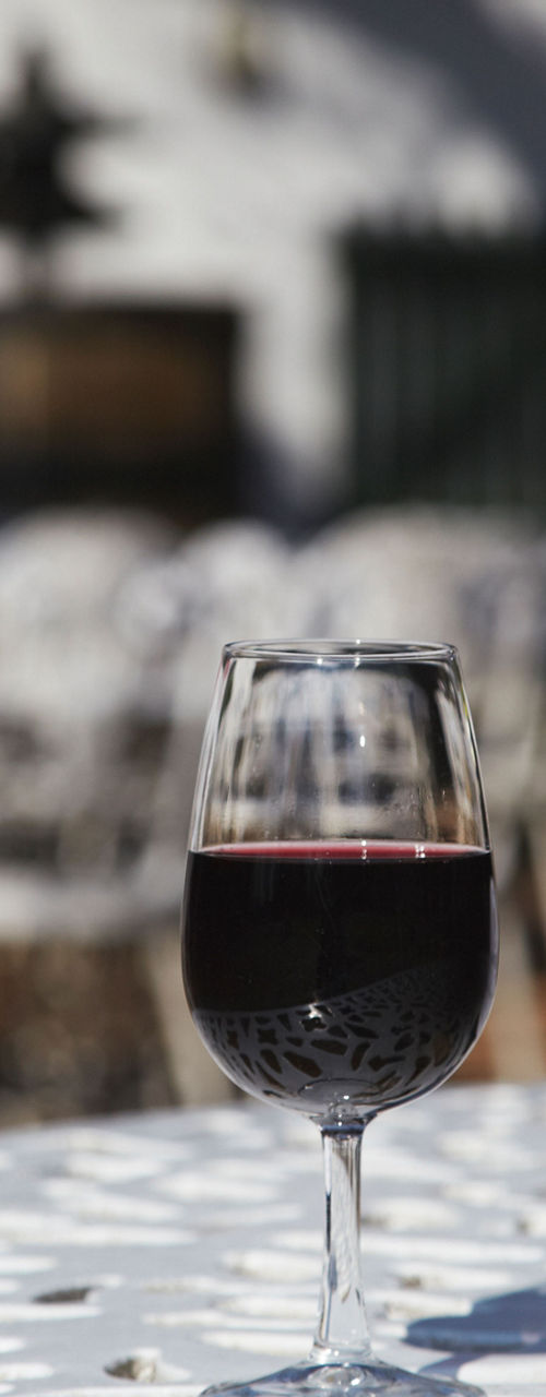 Red wine bottle and glass outdoors