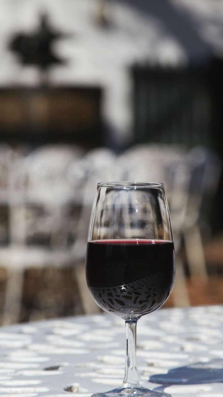 Red wine bottle and glass outdoors