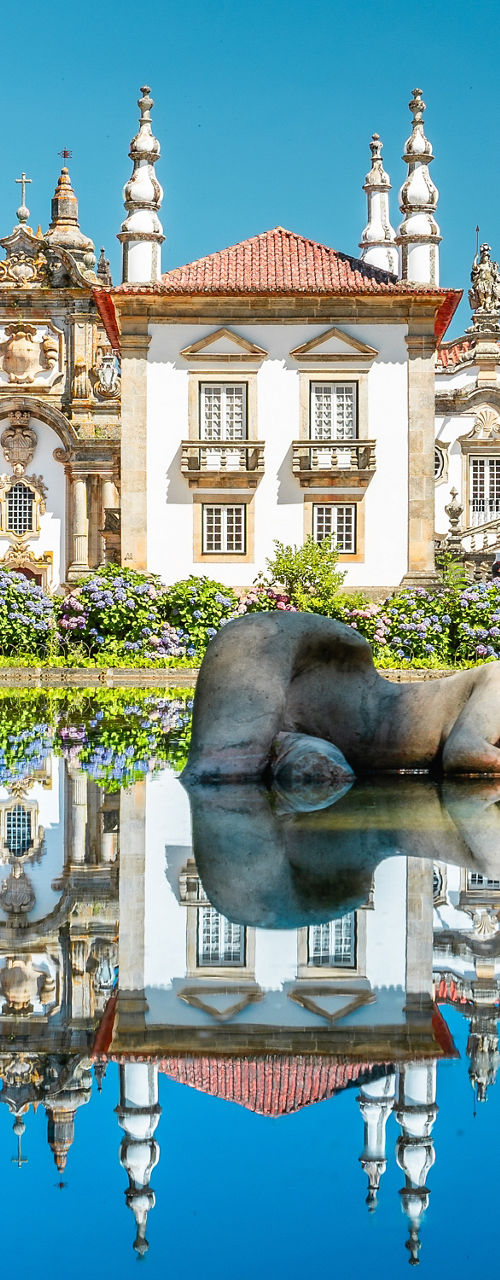 Historic palace with serene water reflection
