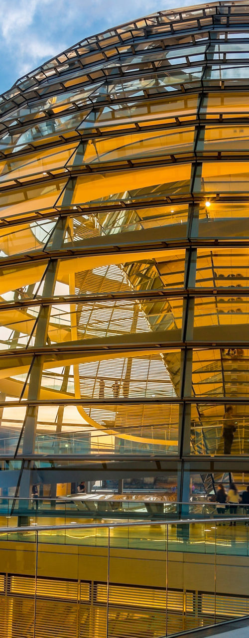 Glass dome at sunset with reflections