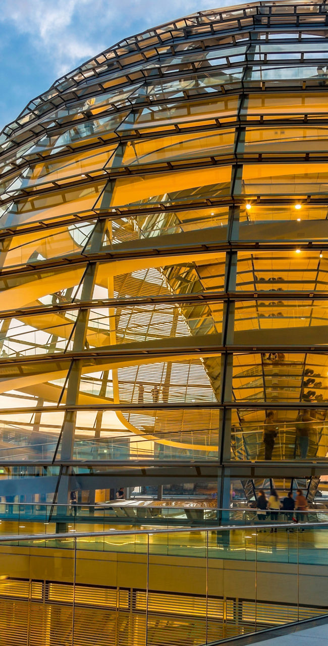 Glass dome at sunset with reflections
