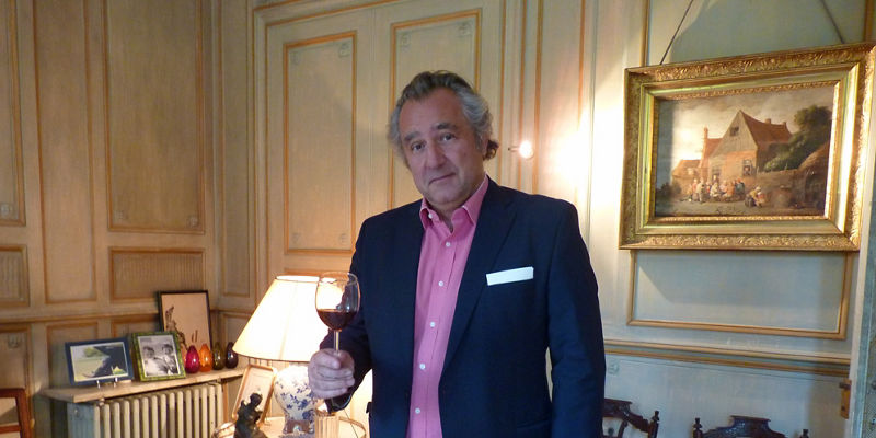 Man holding wine glass in elegant room