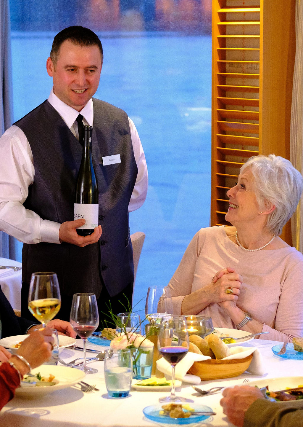 Elegant dining with wine service by lake