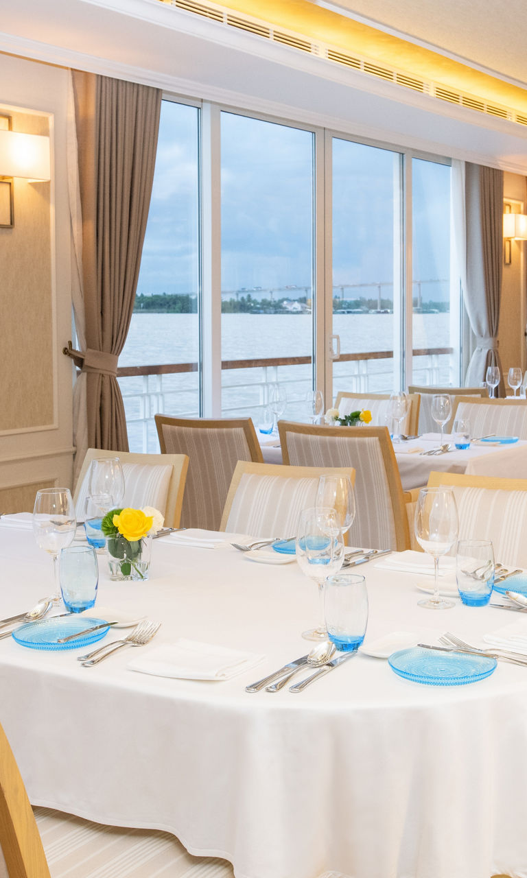 Elegant riverside dining room with large windows