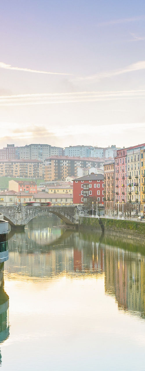Historic riverside view in Bilbao at sunrise