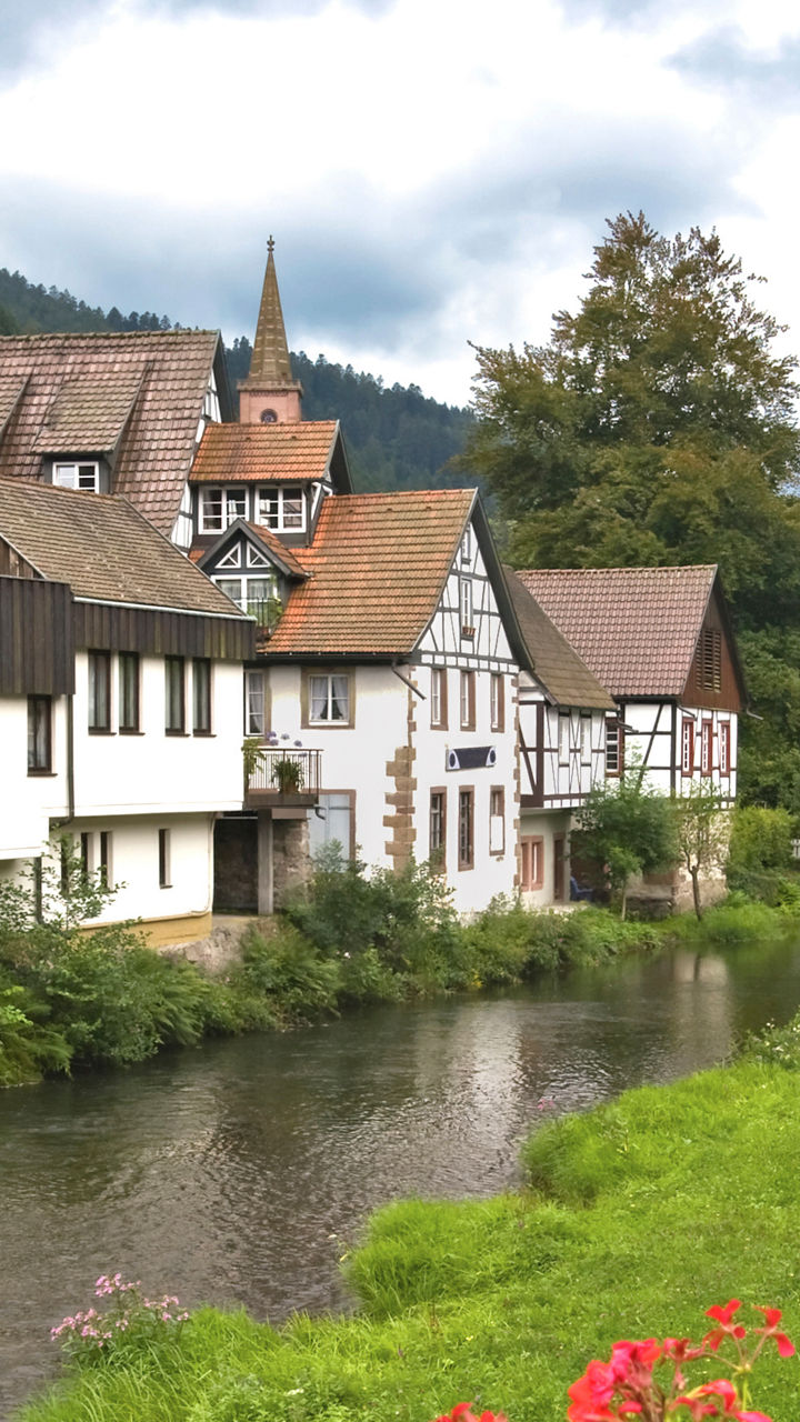 Charming village with river and flowers