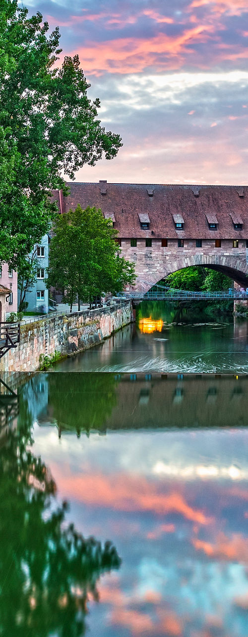 Historic riverside buildings at sunset