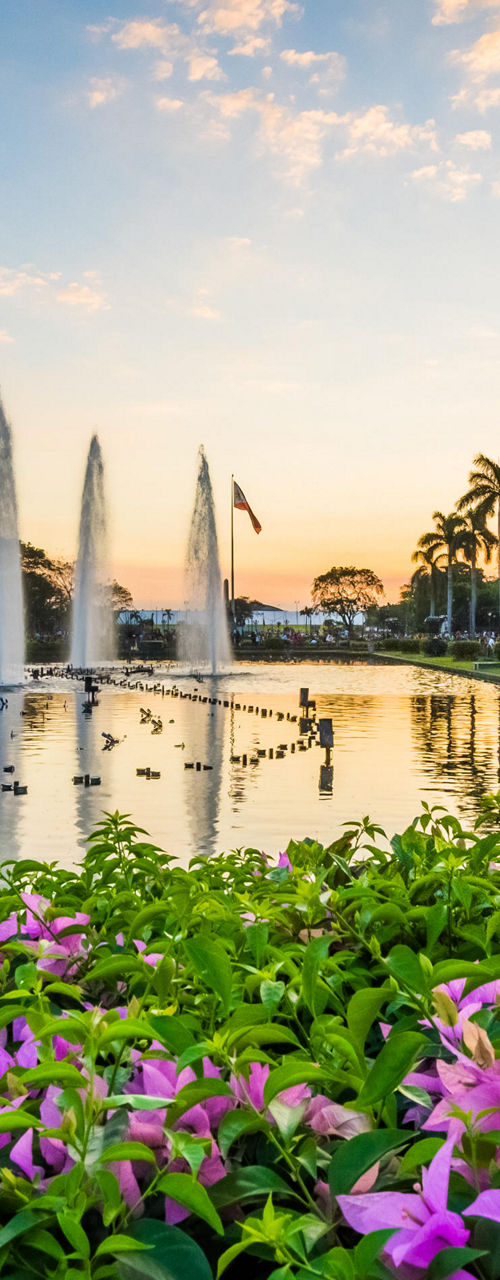Scenic park with fountains at sunset