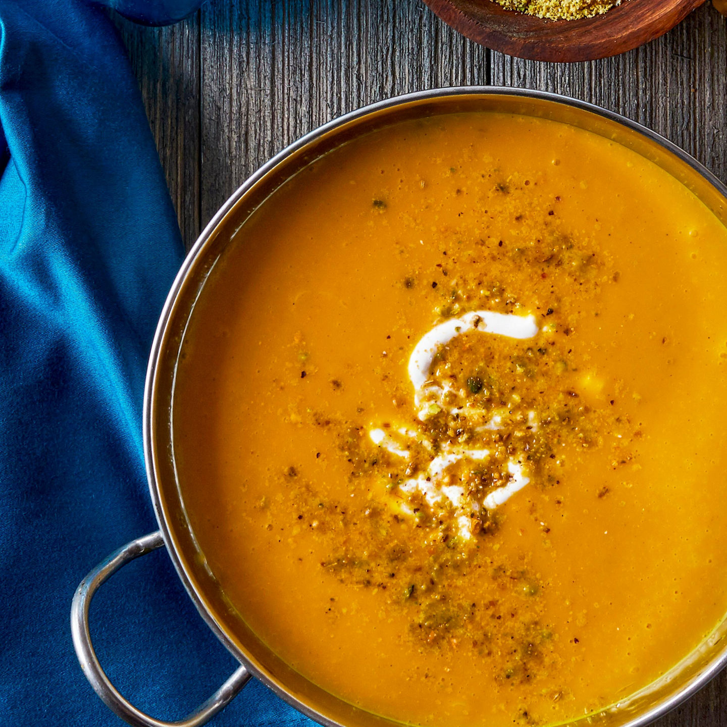 Pumpkin soup with pistachios and blue decor