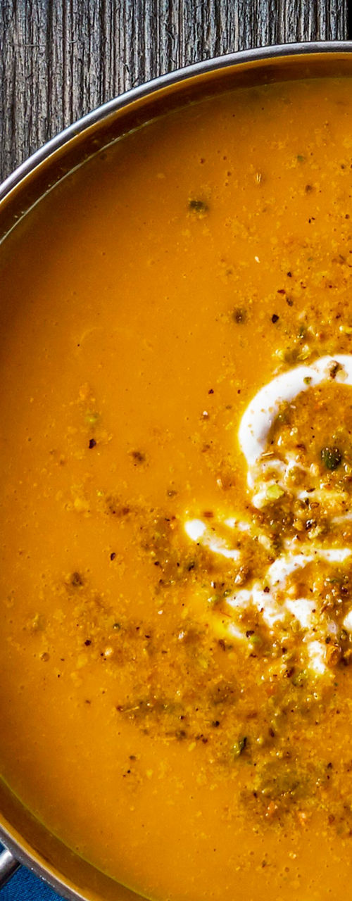Pumpkin soup with pistachios and blue decor