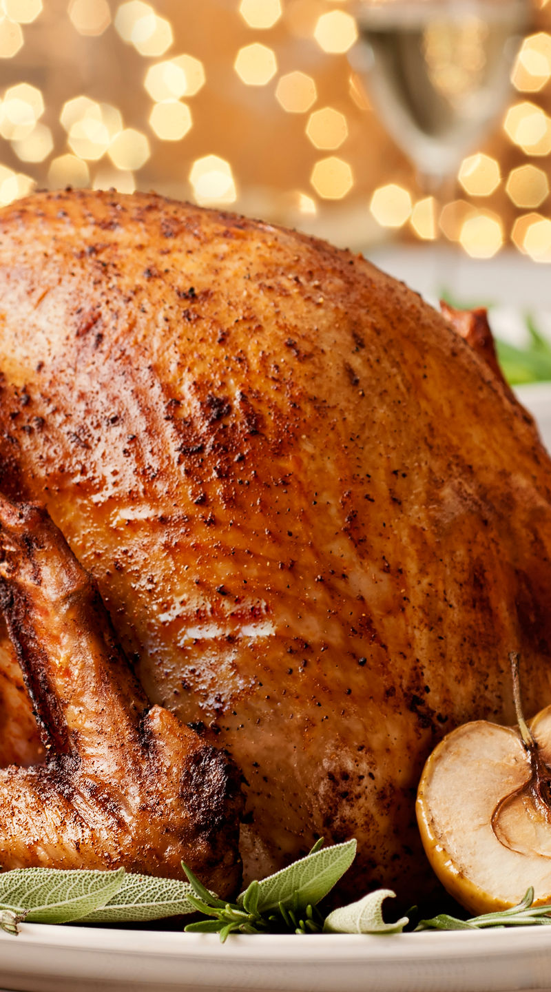 Golden roasted turkey with festive table setting