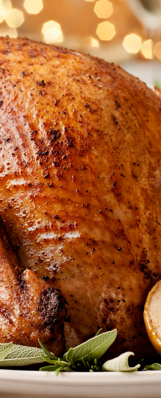 Golden roasted turkey with festive table setting