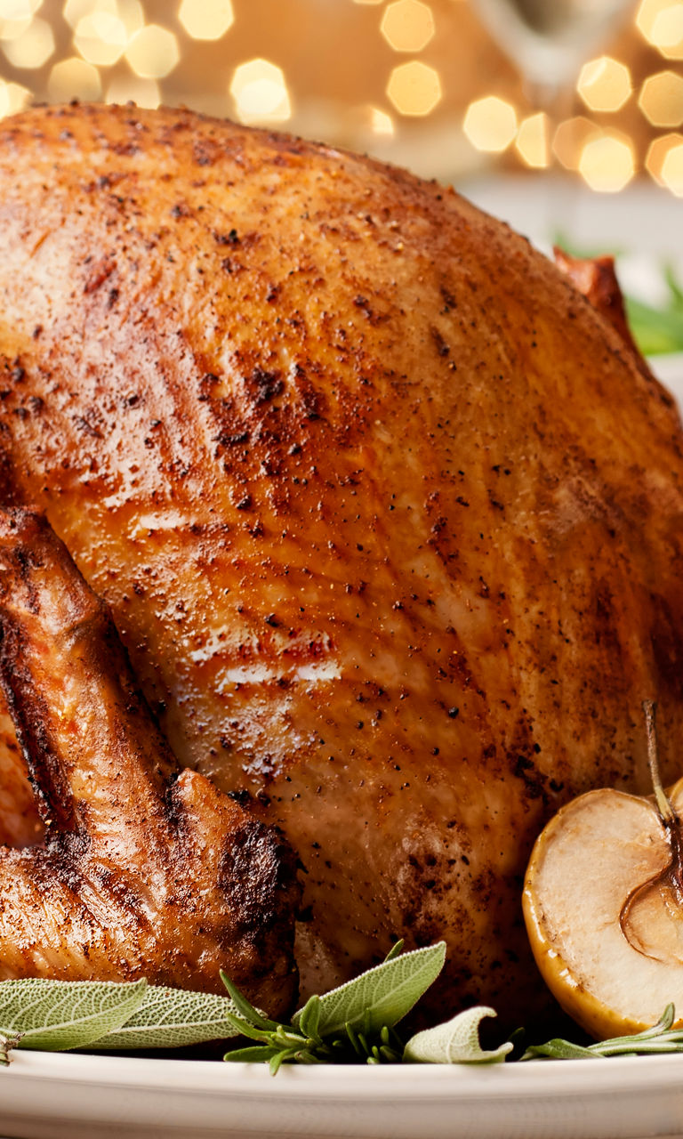 Golden roasted turkey with festive table setting