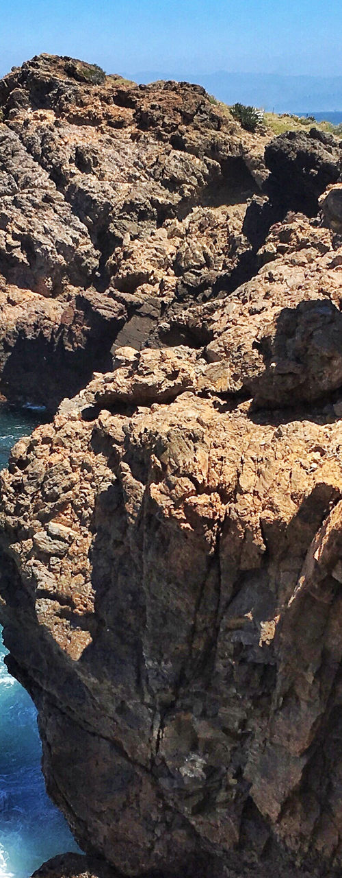 Rocky coastal cliffs with blue ocean view