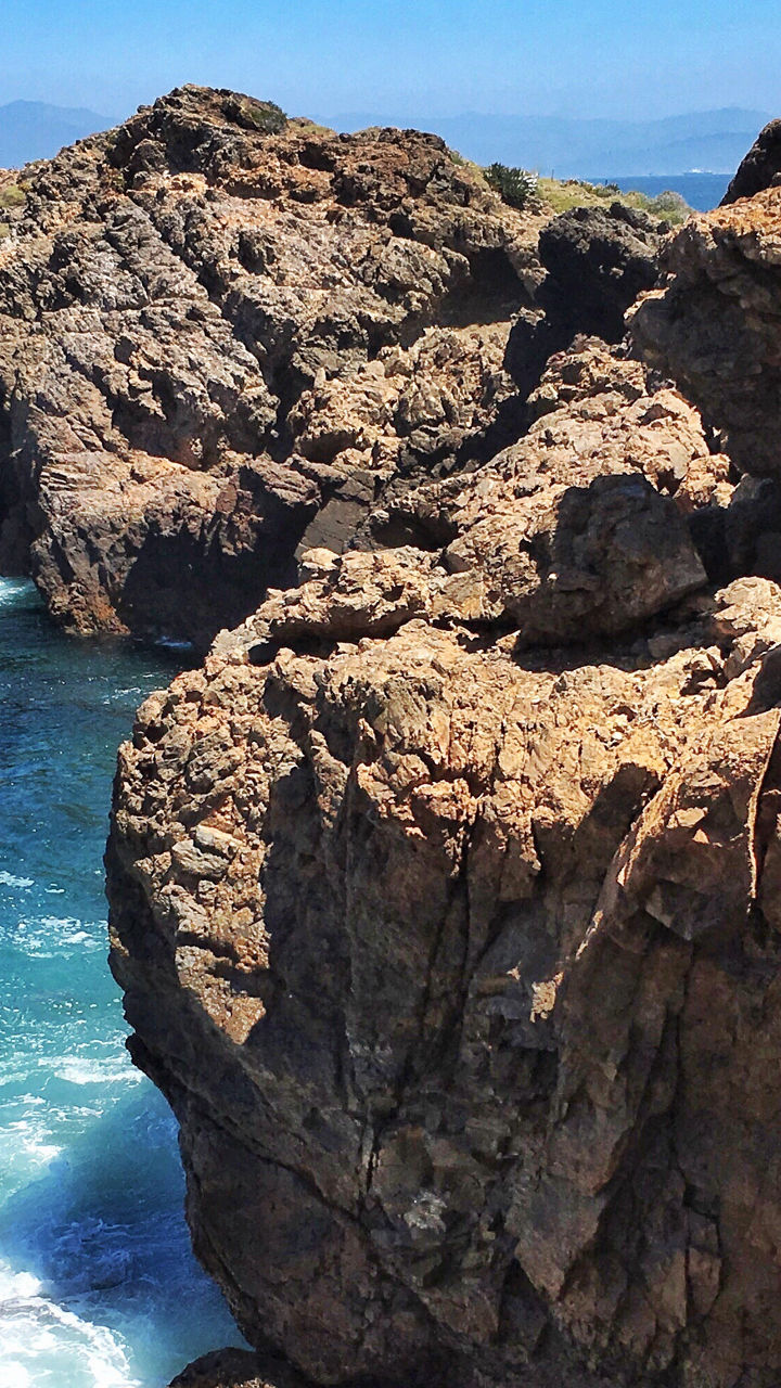Rocky coastal cliffs with blue ocean view