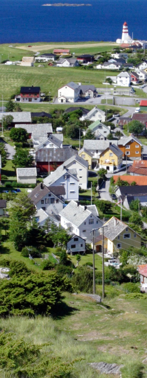 Coastal village with lighthouse and ocean view