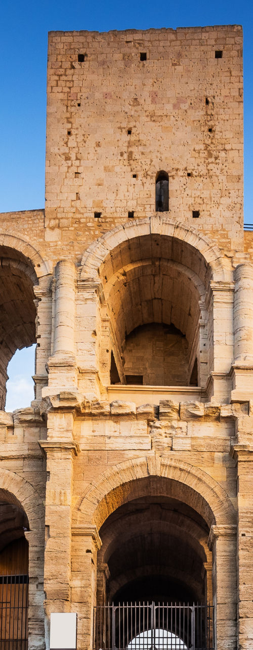 Historic Roman amphitheater under blue sky