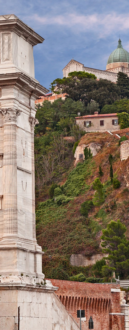 Ancient stone archway overlooking hillside town