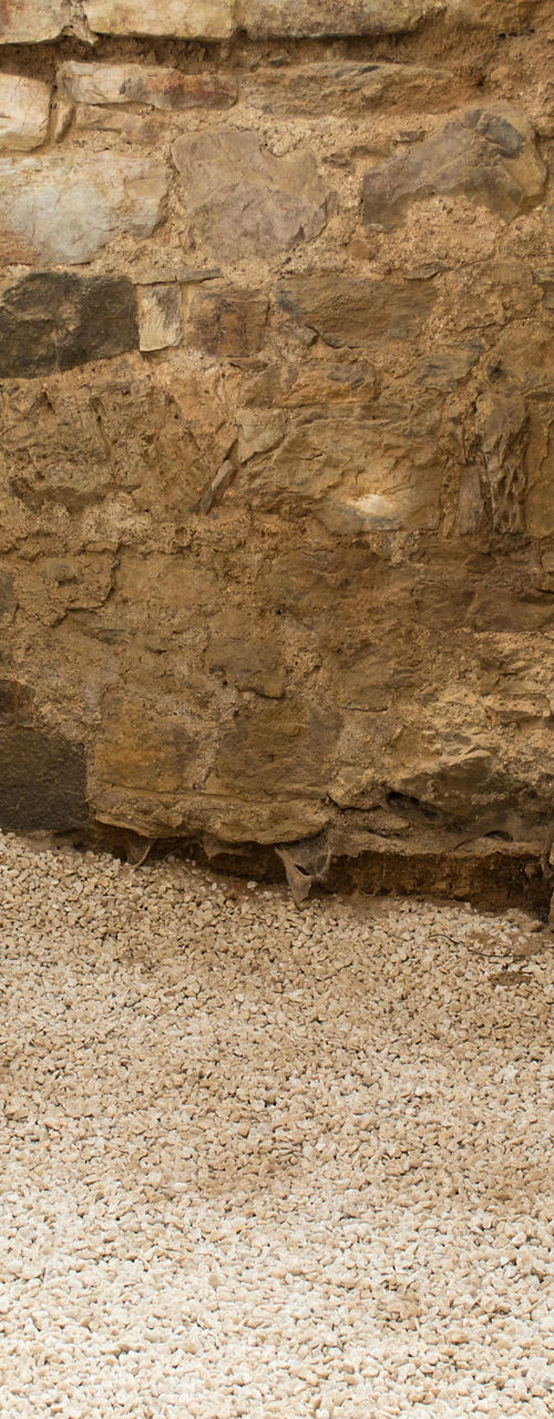 Ancient clay amphorae in rustic stone setting