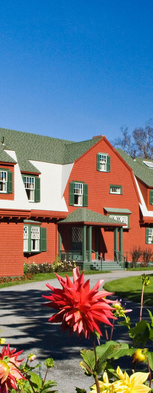 Historic red house with vibrant garden