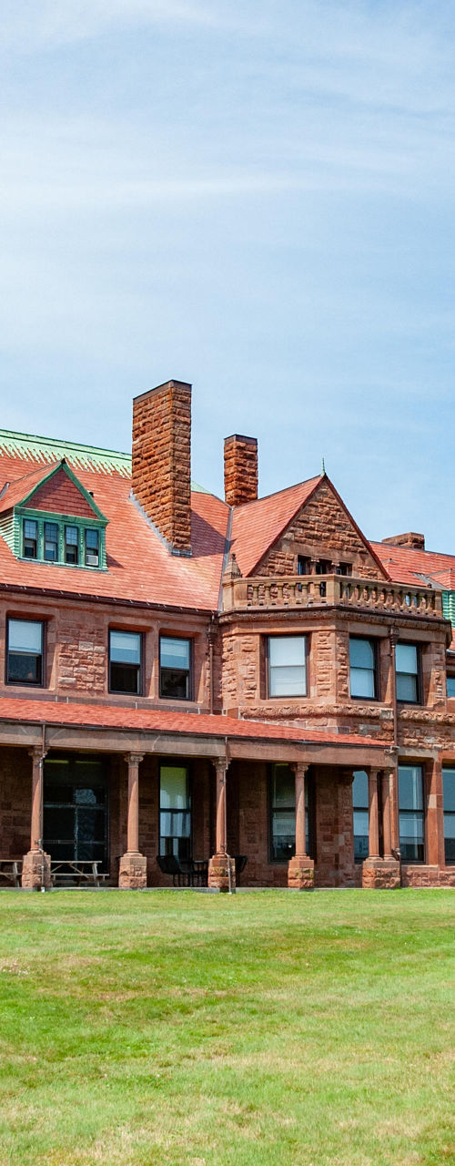 Historic red brick mansion with green roof