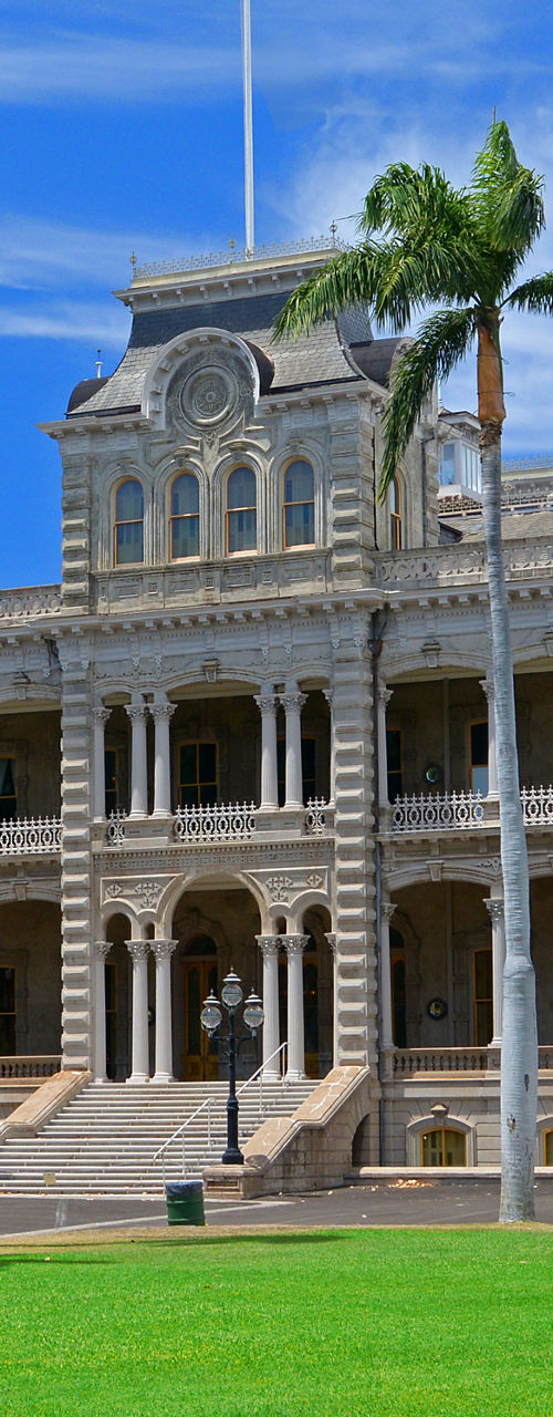 Historic palace building with palm trees