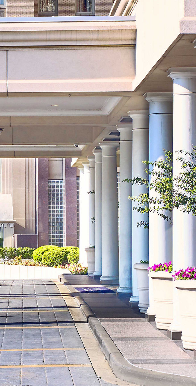 Modern urban plaza with columns and fountain