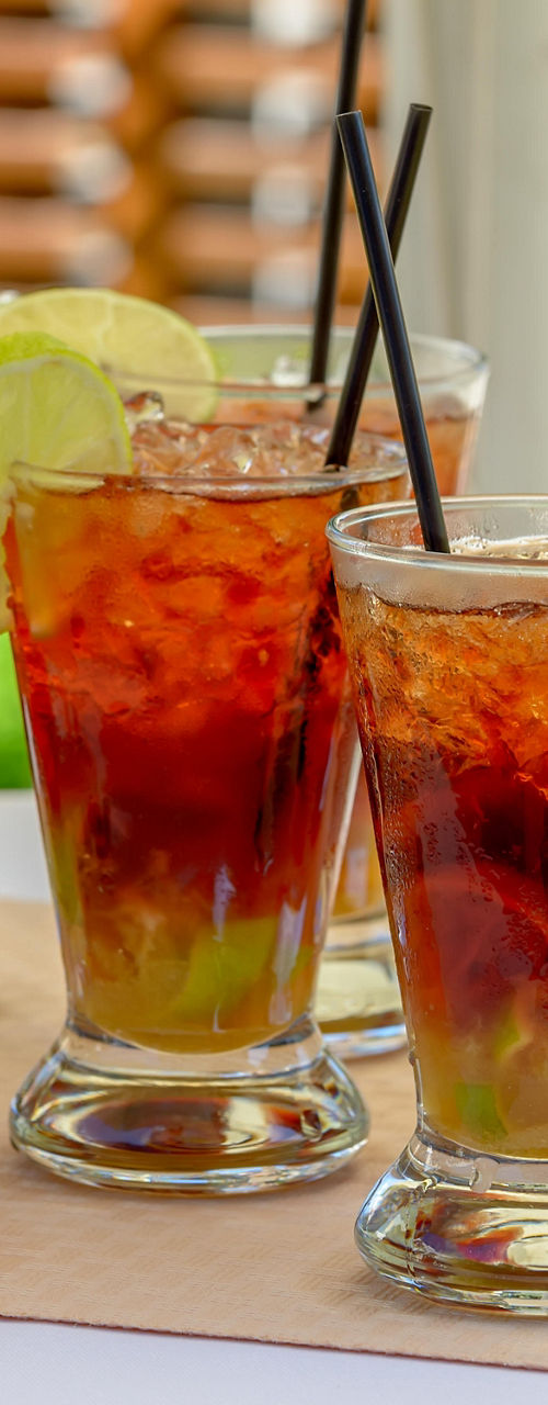 Refreshing iced drinks with lime garnish outdoors