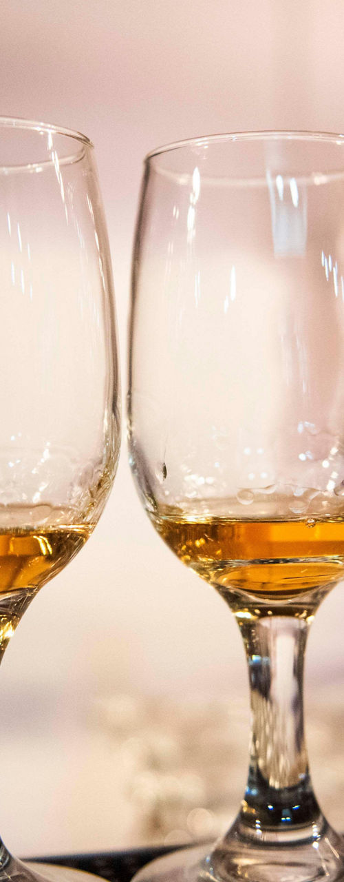Row of whiskey glasses in urban setting