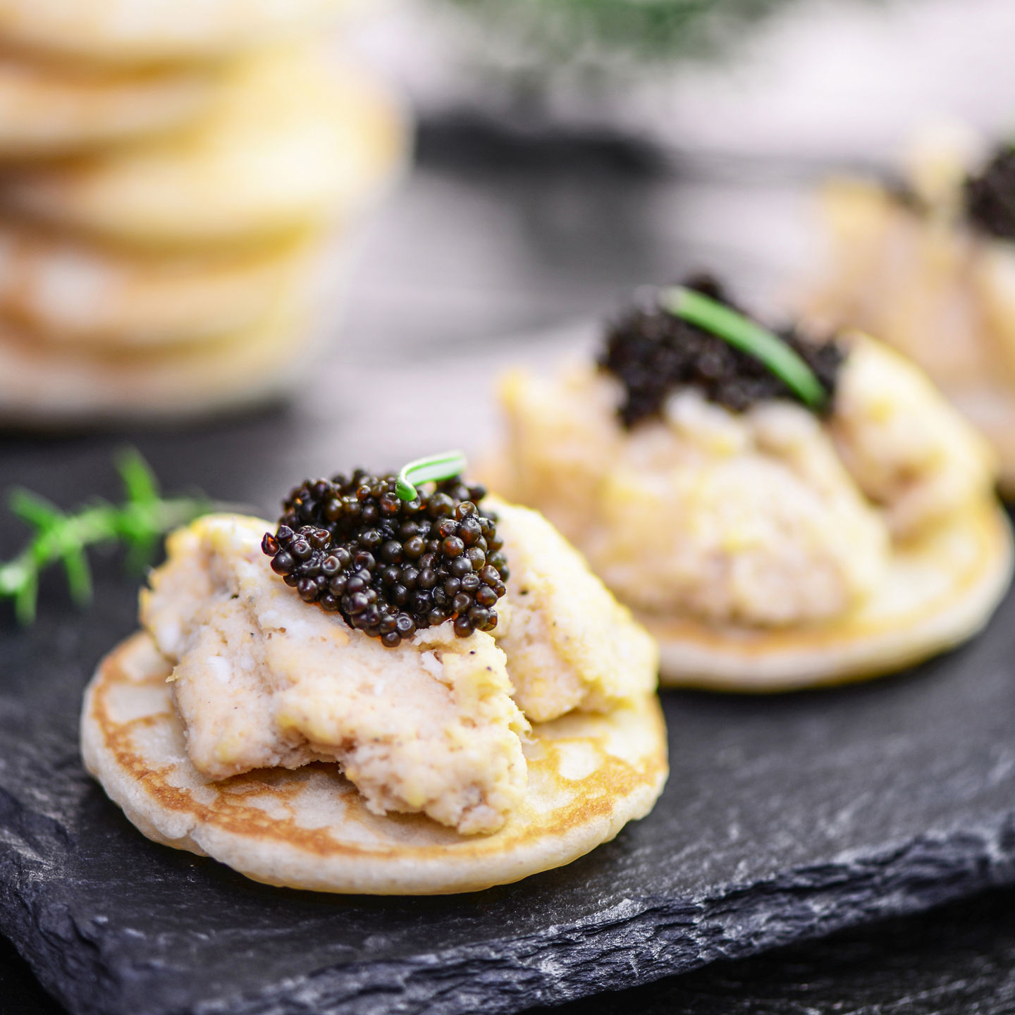 Gourmet canapés with caviar on slate