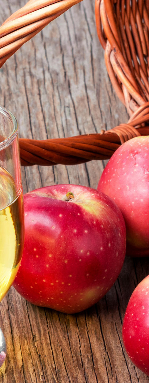 Fresh apples and apple juice on wooden table