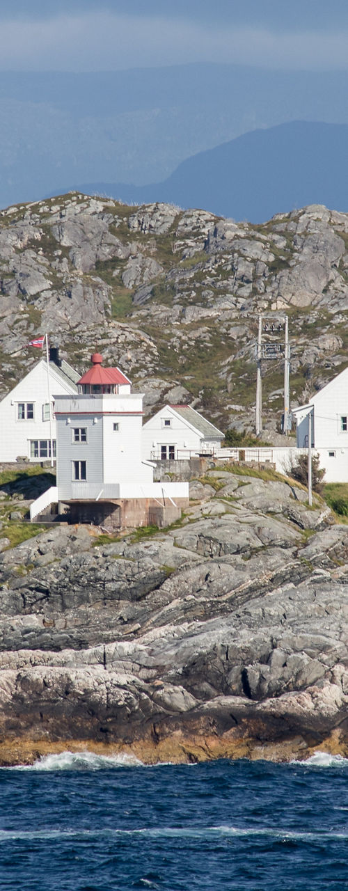 Remote coastal houses on rocky shoreline