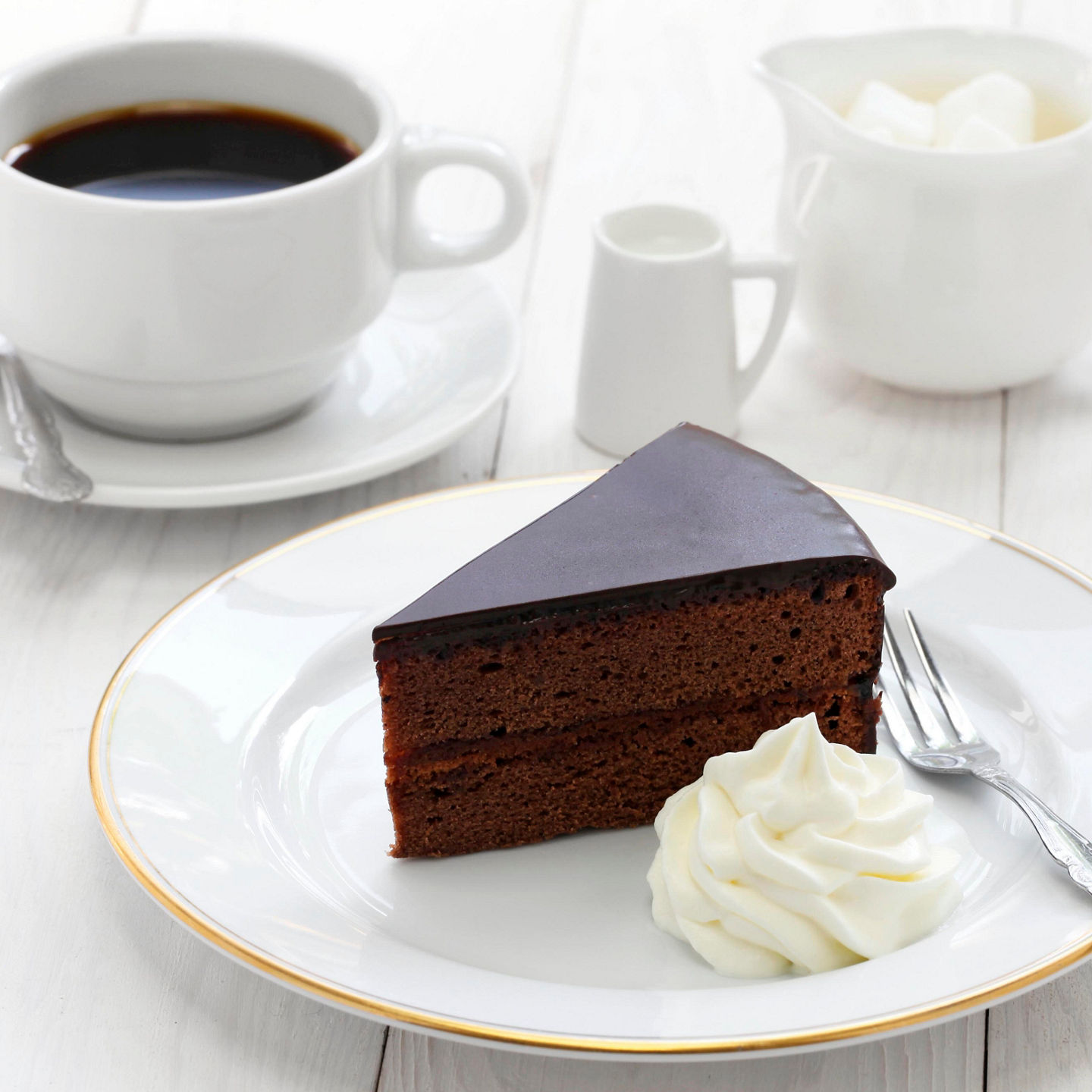 Chocolate cake slice with coffee and cream