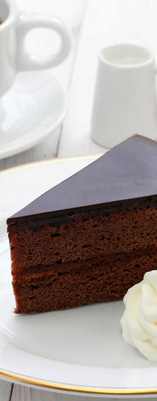 Chocolate cake slice with coffee and cream