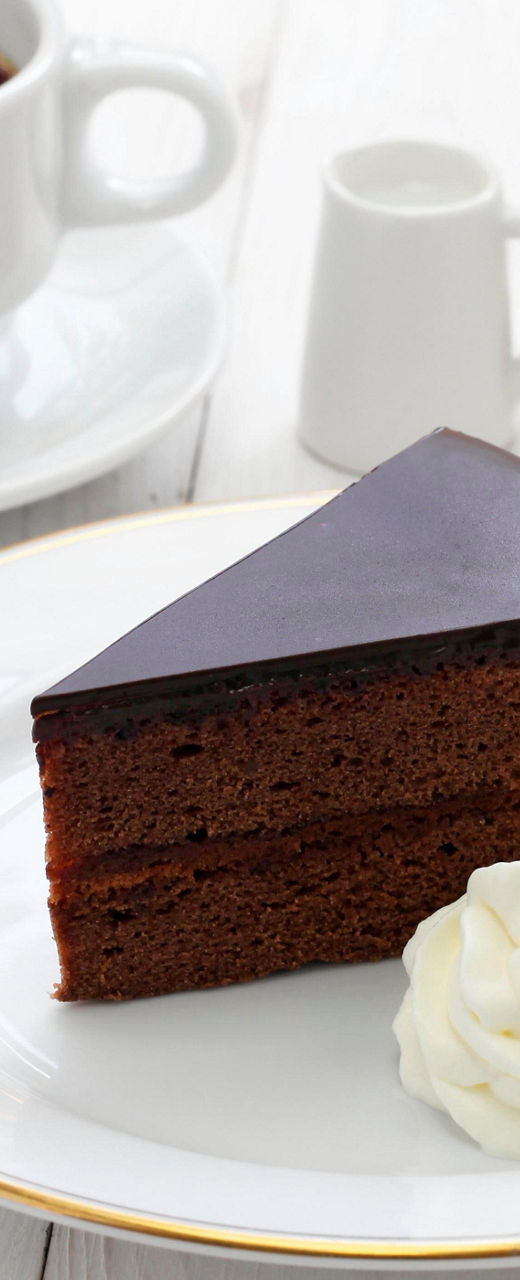 Chocolate cake slice with coffee and cream