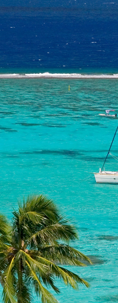 Sailboat on turquoise tropical waters