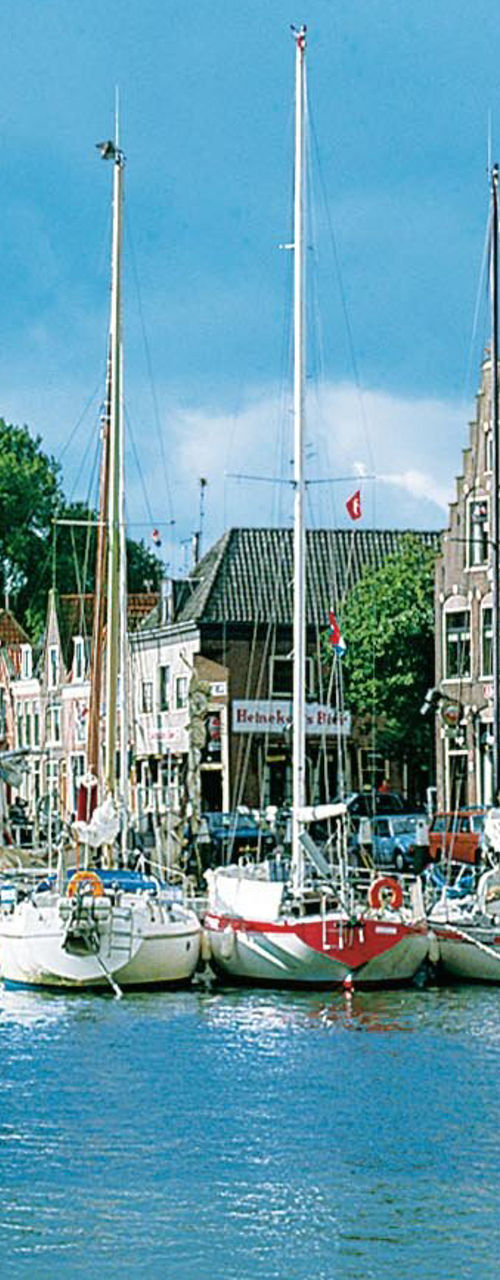 Historic harbor with sailboats and buildings