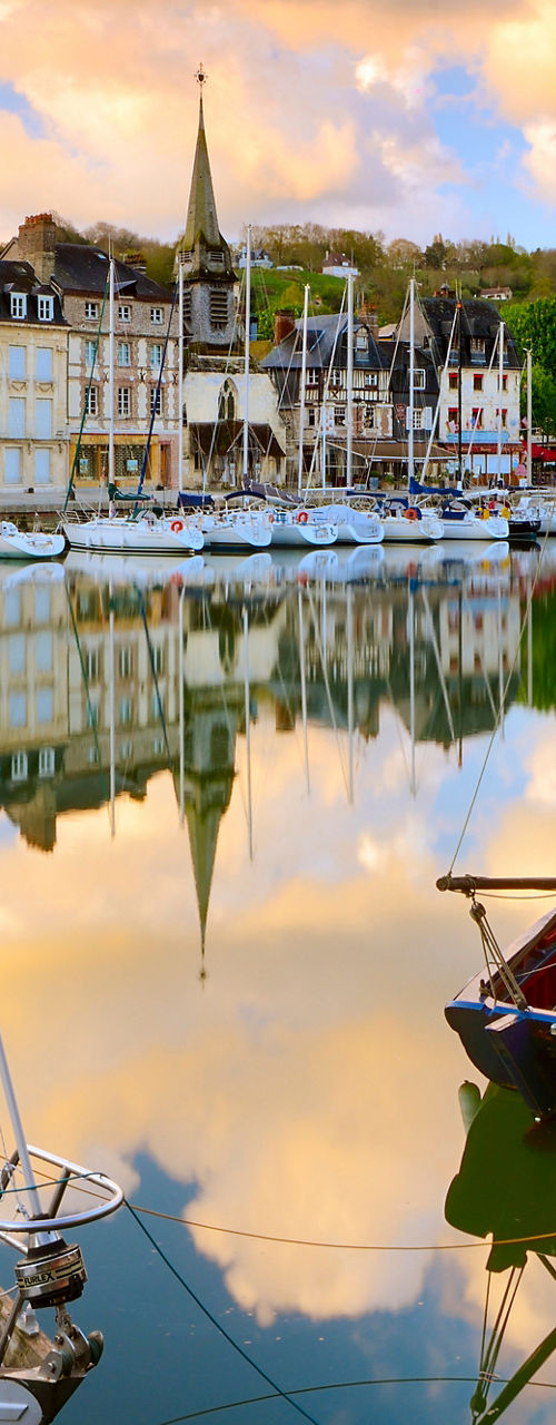 Scenic harbor with sailboats at sunset