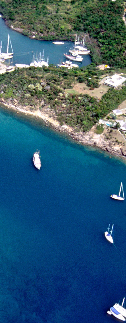 Aerial view of sailboats in tropical bay