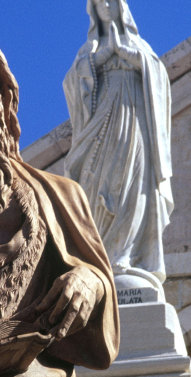 Religious statues with church backdrop