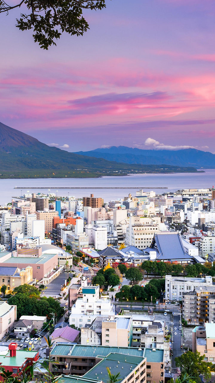 Cityscape with mountain and vibrant sunset sky