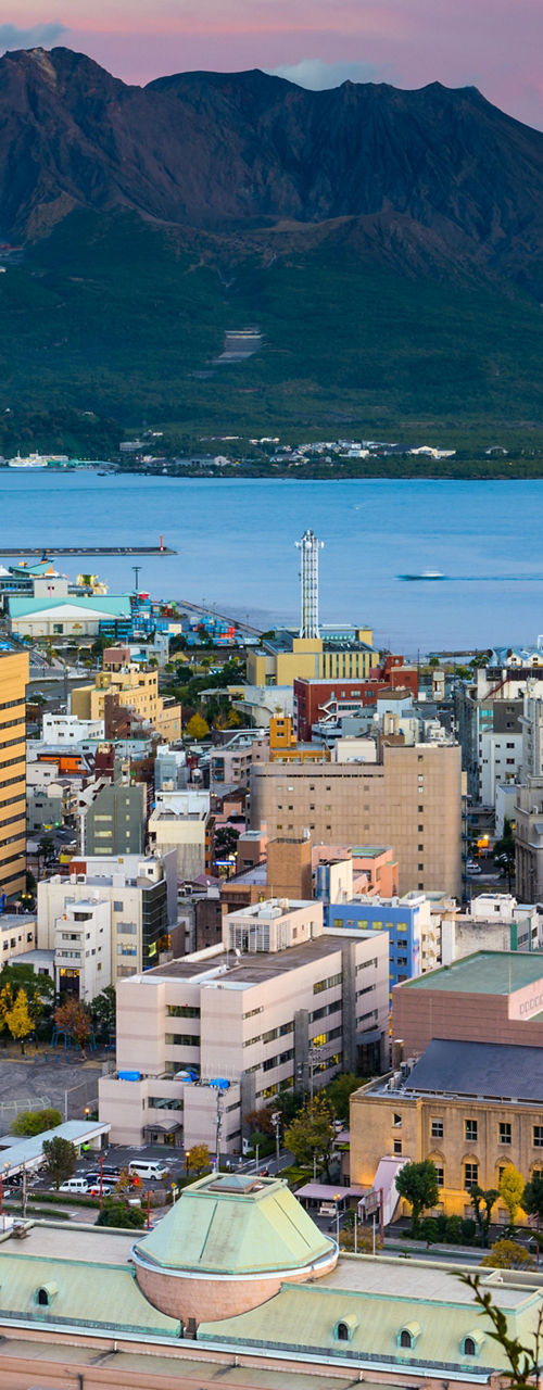 Cityscape with Sakurajima volcano at sunset