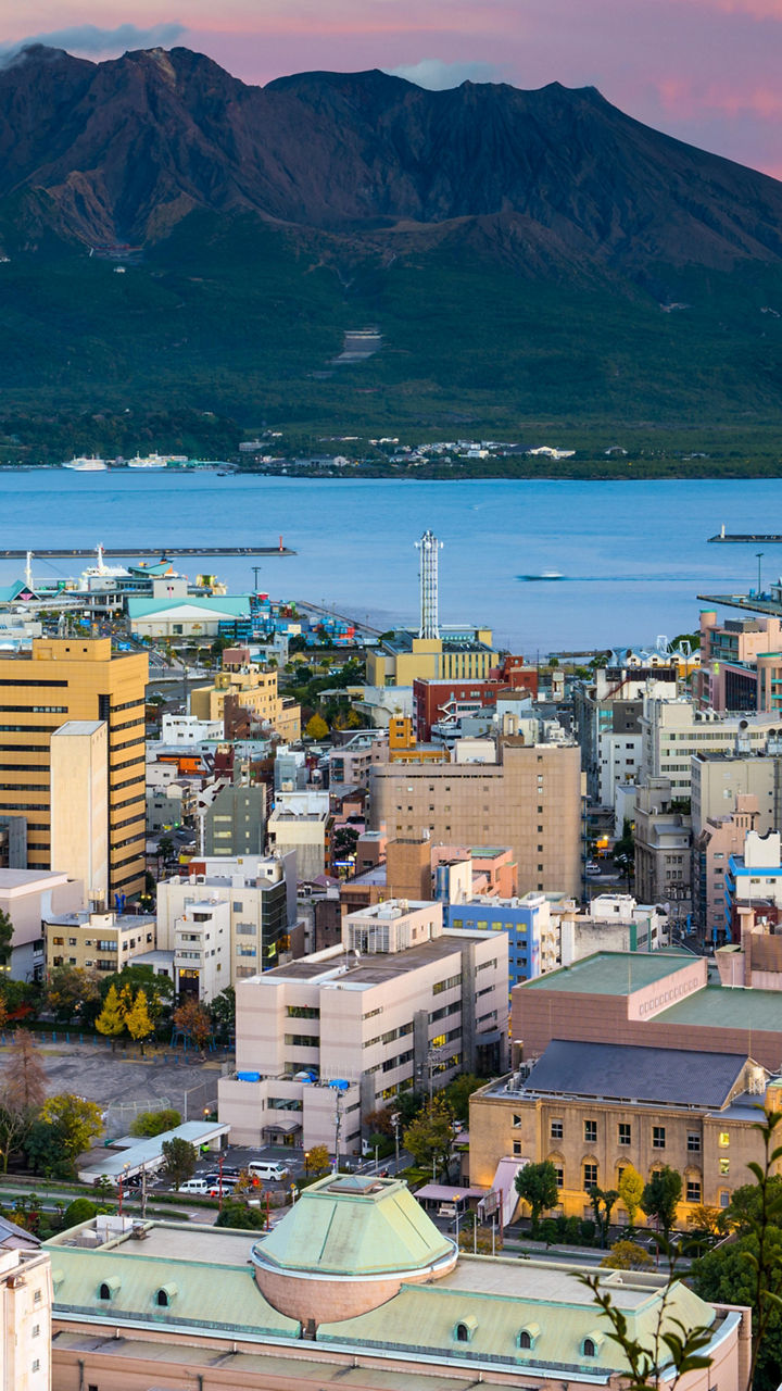 Cityscape with Sakurajima volcano at sunset