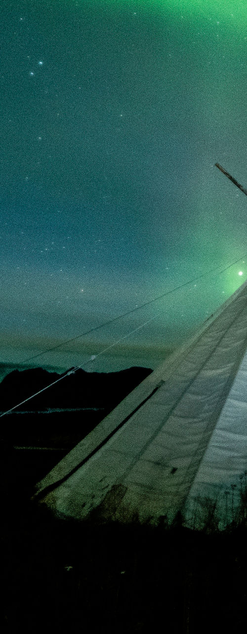 Northern lights over traditional tent