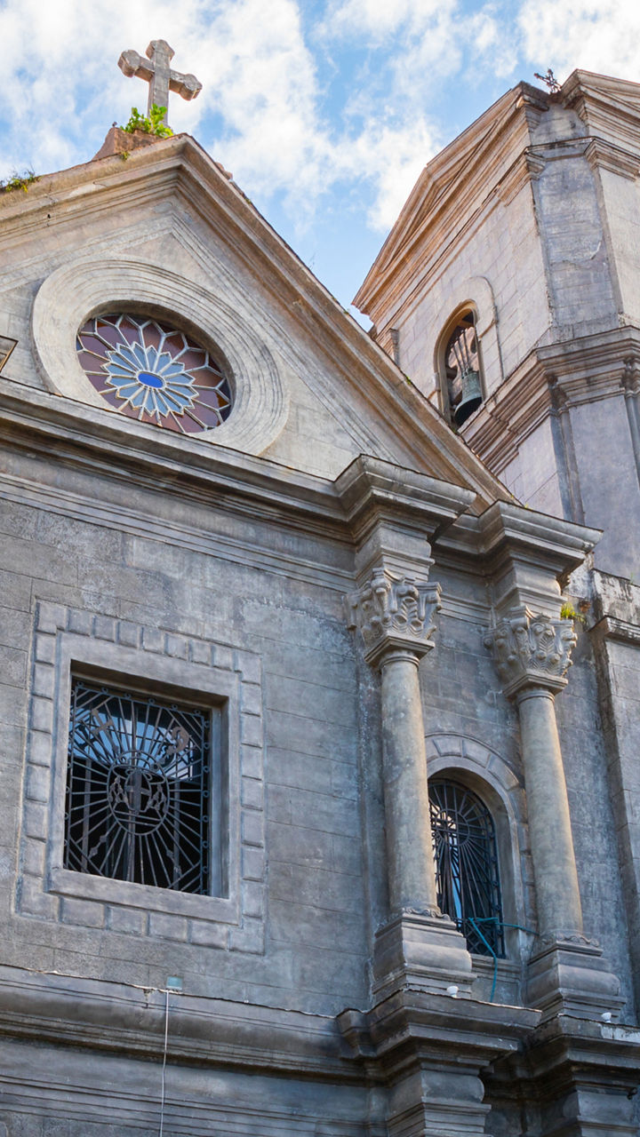 Historic stone church facade under blue sky