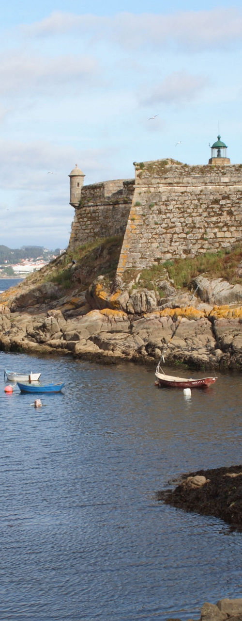Historic stone fortress by calm waterfront