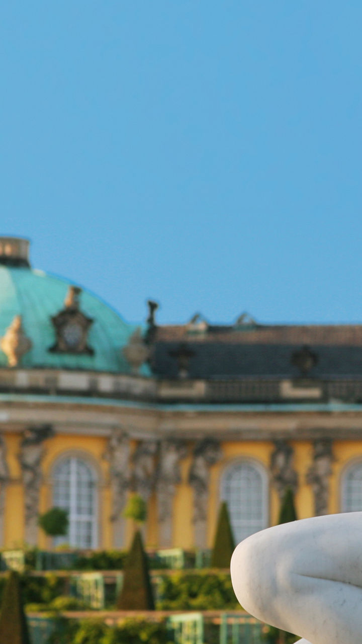 Classical Statue with Historic Palace View
