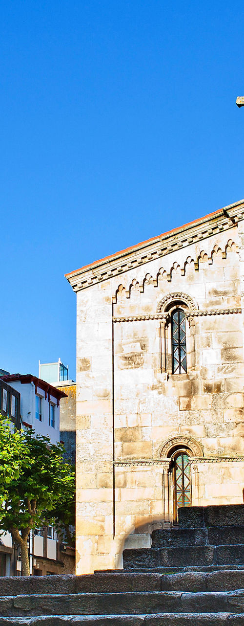 Historic stone church with walking visitors