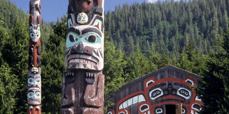Traditional totem poles in forest setting