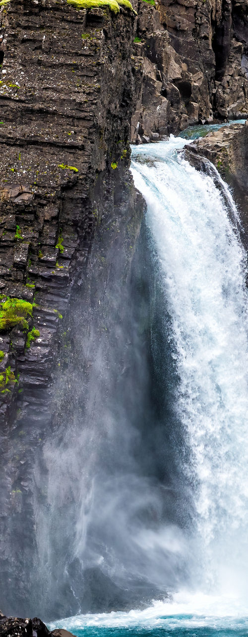 Majestic waterfall in rocky canyon landscape